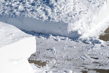 Fototapeta na wymiar Plowed Snow on the Sidewalk