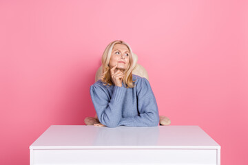 Photo of dreamy doubtful woman wear pullover smiling finger chin looking empty space isolated pink...