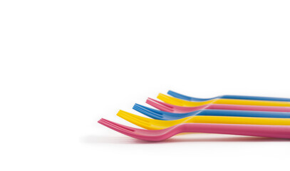 Set of colourful children plastic forks graduated side view white background. Concept of reusable plastic utensils, kids parties lunch dinner, sustainable living, nursery school