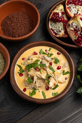 Creamy chicken curry with pomegranate and parsley