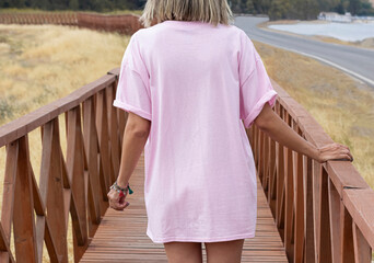 Young girl wearing blank back oversized pink t shirt , pink t shirt mock up , back pink tshirt for...