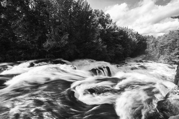 Long exposure of Petawawa river rapids in Algonquin Park Ontario Canada in black and white.