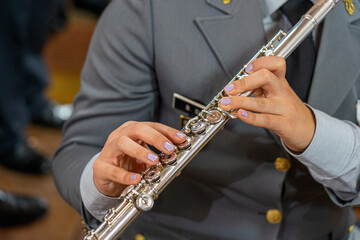 transverse flute to be played by a woman in a gray military uniform. © Pedro Emanuel 