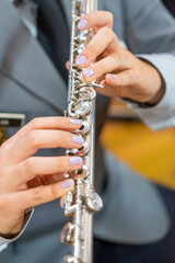 transverse flute to be played by a woman in a gray military uniform.