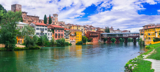 Beautiful medieval towns of Italy -picturesque Bassano del Grappa .Scenic view with famous bridge. Vicenza province, region of Veneto. - obrazy, fototapety, plakaty