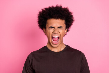 Closeup photo of emotional madness stressful young funny angry guy wear brown shirt screaming burnout isolated on pink color background
