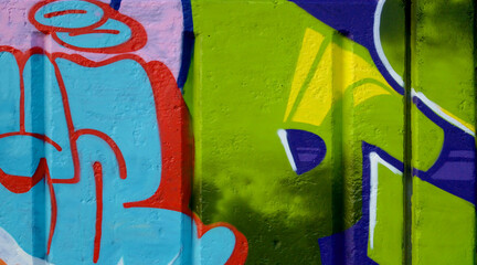 Colorful background of graffiti painting artwork with bright aerosol outlines on wall. Old school...