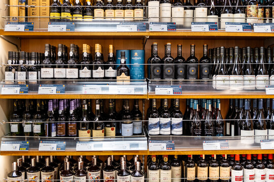 Wine bottles lined up on a shelf in a shop
