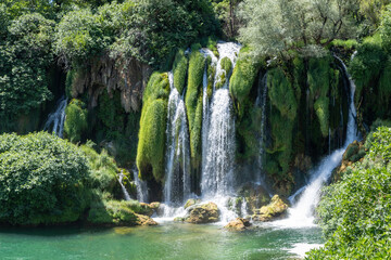 Fototapeta na wymiar Vodopad Kravica, Kravice waterfall, a large tufa cascade on the Trebižat River, in the karstic heartland of Herzegovina in Bosnia and Herzegovina