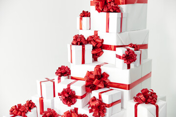 A lot of white gift boxes with red bow on white background decoration