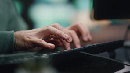 Programer hands typing keyboard working computer in data center room closeup