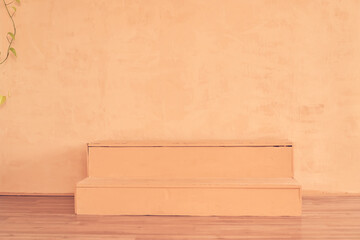 Podium in the form of ladder for placing goods, products for advertising. Mock up, template for presentation, show product. Background with copy space, peach fuzz color. Concept for your design.