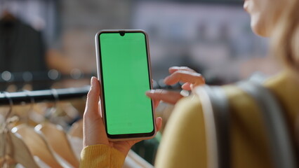 Shopaholic browsing greenscreen smartphone online mall closeup. Woman shopping