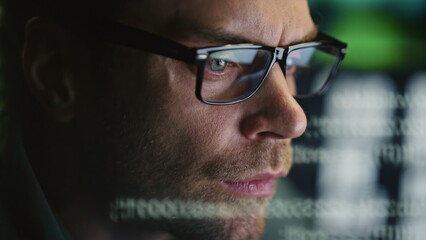 Focused programer face watching computer in data hologram closeup. Man coding