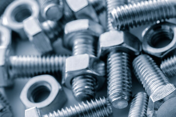 Metal nuts close up as a graphic industrial background