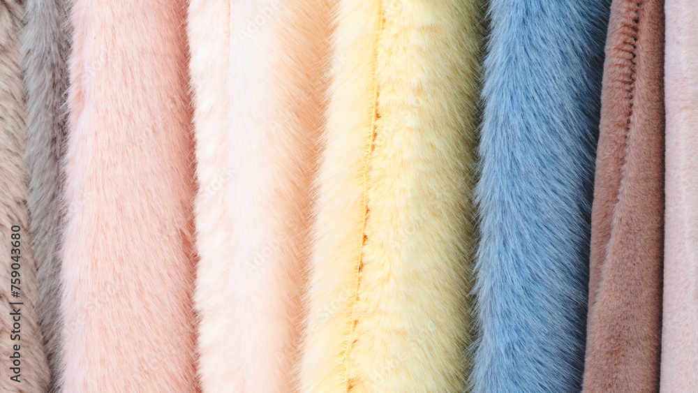 Poster multi-colored textile fabrics hang in a market or store as an abstract background
