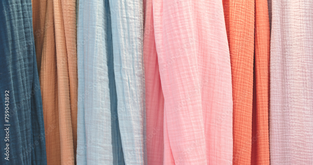 Aufkleber multi-colored textile fabrics hang in a market or store as an abstract background
