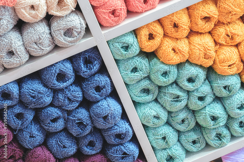 Poster Multi-colored skeins of wool on display in a store as a background