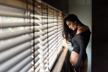 Asian sexy tan woman stand by window with natural light
