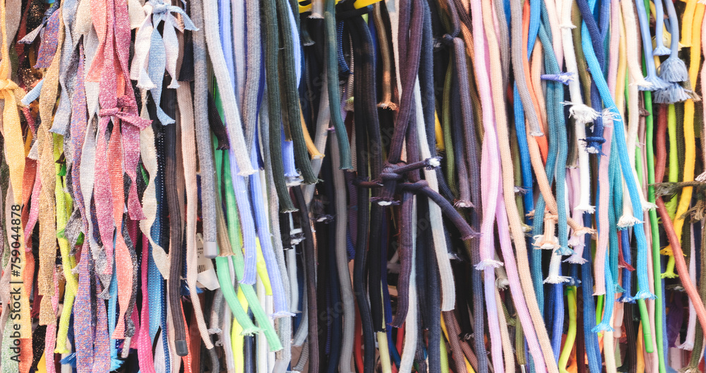 Aufkleber a row of colorful strings laces are displayed in a store. the colors are bright and vibrant, creatin