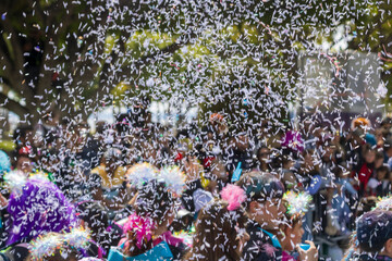 Fake snow in front of crowd of people at Carnival Parade  