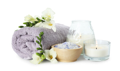 Obraz na płótnie Canvas Spa composition. Towel, burning candles, sea salt and beautiful flowers on white background