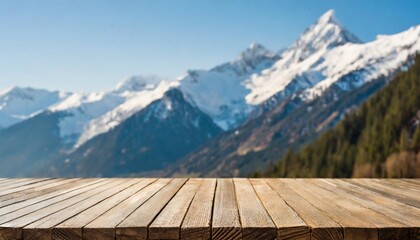 empty wooden table top with blur background of snow capped mountains