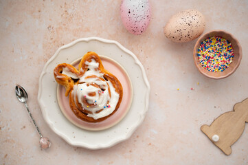 Fresh homemade Cinnamon Rolls pastries covered in cream cheese icing for Easter. Easter festive...