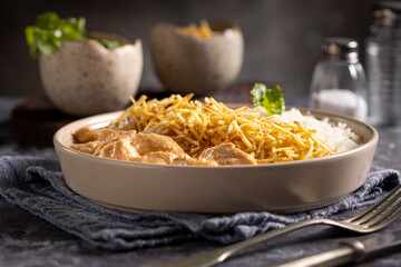 Chicken stroganoff with rice and straw potatoes. Strogonoff.