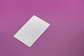 plastic hotel keycard islated on solid color background (rectangular access key card) pink magenta