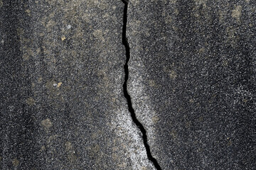 Crack on the wall. Gray grunge abstract background. Texture of an old cement cracked wall.