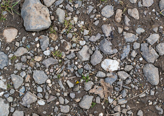 Closeup of a dirt road with rocks/gravel. Usable for graphic designs