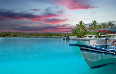 Foto op Plexiglas Colourful sunset at the maldive island with a boat and boardwalk © Stockwerk-Fotodesign