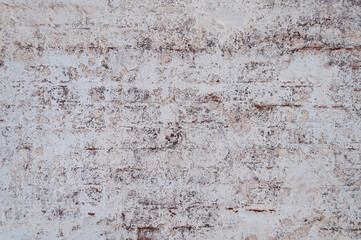 Background of old weathered brick wall covered with lime