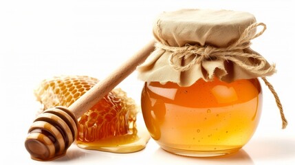 a jar of natural honey next to a wooden honey dipper.