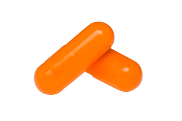 Orange capsules or pills isolated on white background.