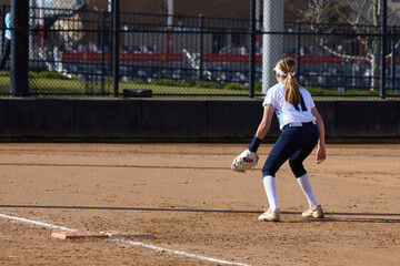 Young female Softball player playing youth sports.