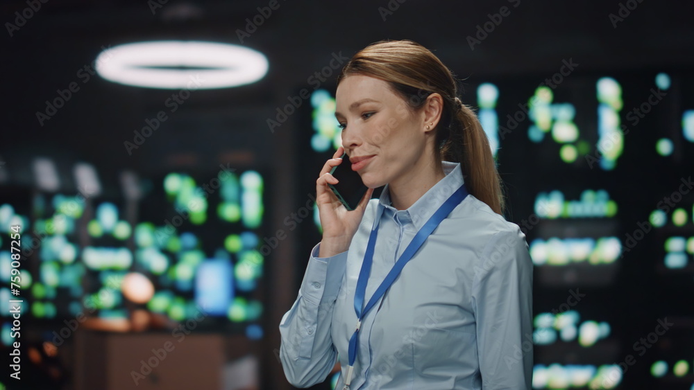 Poster it engineer talking smartphone upgrading hardware in rack server room closeup