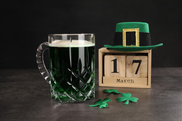 St. Patrick's day celebrating on March 17. Green beer, wooden block calendar, leprechaun hat and...