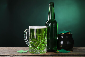 St. Patrick's day party. Green beer, leprechaun pot of gold and decorative clover leaves on wooden...