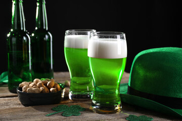 St. Patrick's day party. Green beer, nuts, leprechaun hat and decorative clover leaves on wooden...