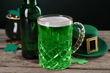 St. Patrick's day party. Green beer, leprechaun hat, pot of gold and decorative clover leaves on...