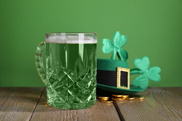 St. Patrick's day party. Green beer, leprechaun hat, gold and decorative clover leaves on wooden...