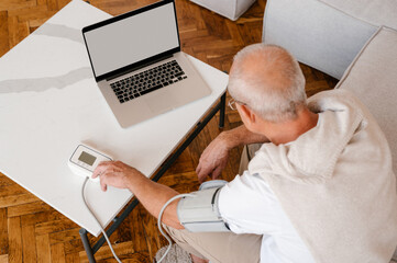 Unrecognizable elderly man having appointment with online doctor
