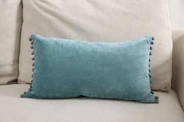 Soft pillows on beige sofa in room