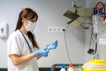 Female nurse preparing medication for injection