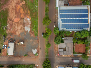 Aerial top down of solar panels on roof and rural road in Tangara da Serra in Mato Grosso