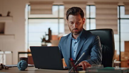 Angry director picking phone up at office work desk closeup. Man boss yelling