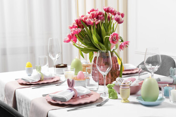 Festive table setting with beautiful flowers. Easter celebration