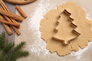 Obraz na płótnie Canvas Making Christmas cookies. Flat lay composition with ingredients and raw dough on grey table